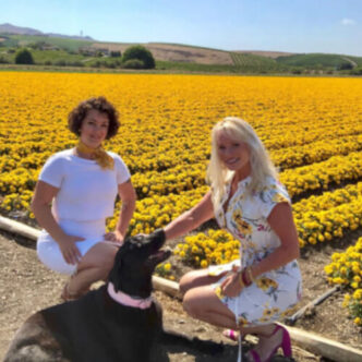 san luis obispo assisted living specialists wearing spring dresses in front of a field of yellow flowers